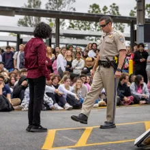 police officer with student actor
